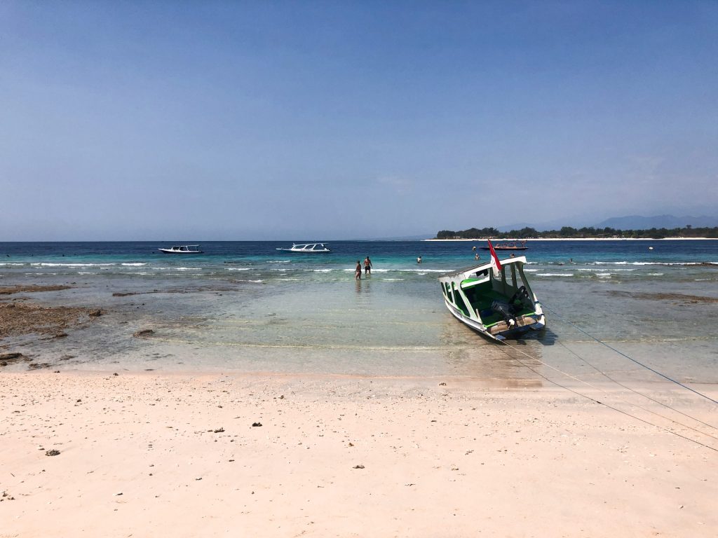 beach in gili t during low tide with boat