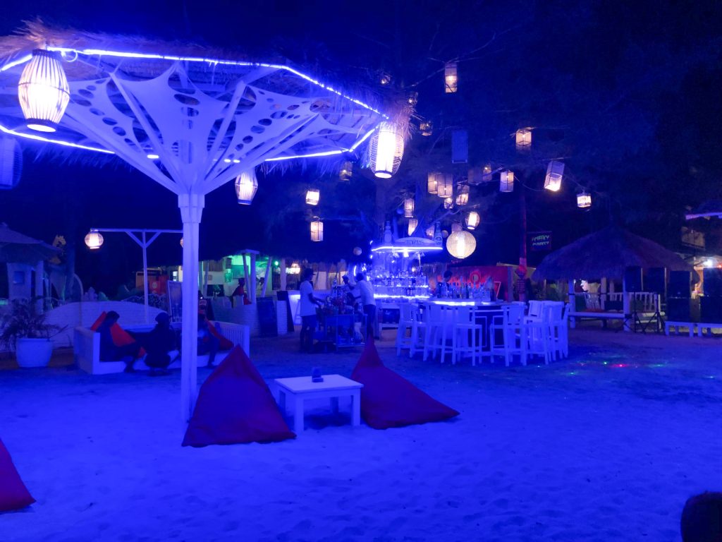 Blue neon lit bar in Gili Air with bean bags in the sand