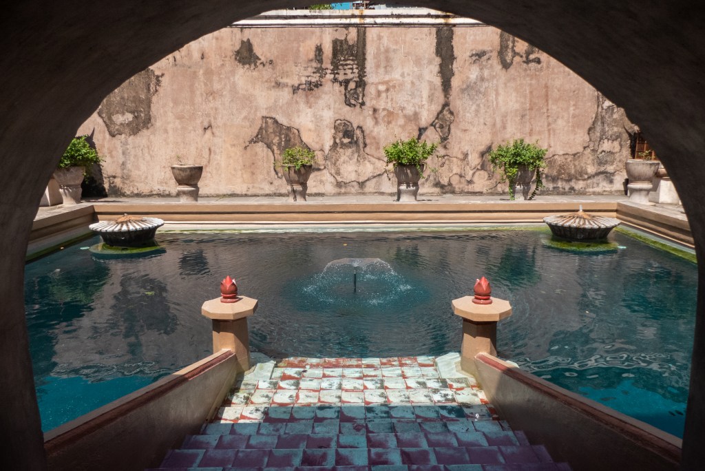 taman sari water palace pink walls blue swimming pool