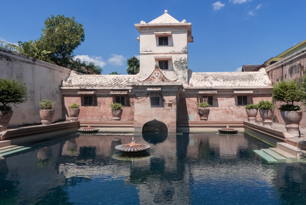 taman sari unique things to do yohyakarta pink water palace with blue sky and pools