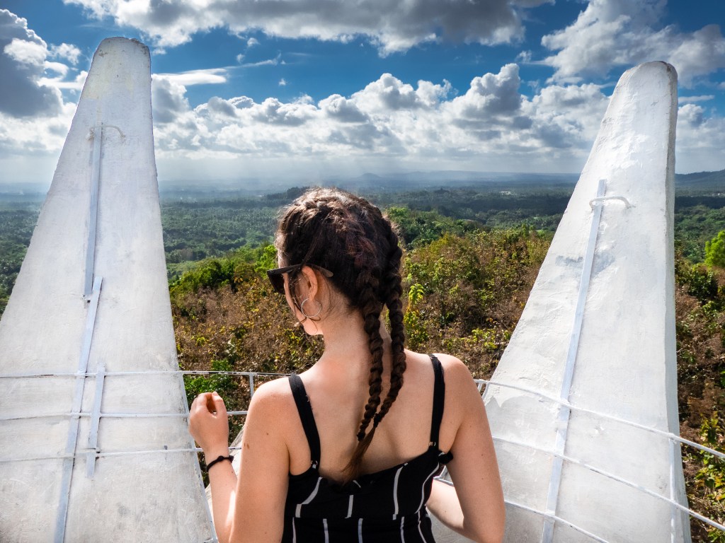 girl standing on top of bukit rhema chicken church