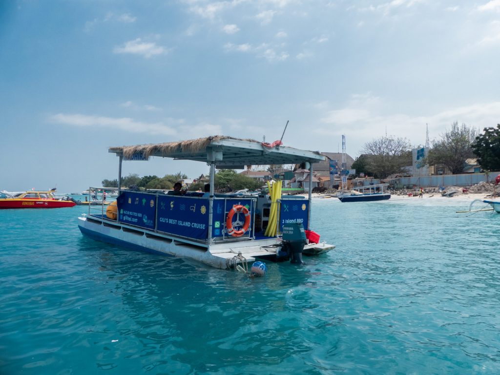 BBQ pontoon in the gili islands with white beach and blue waters boat tour