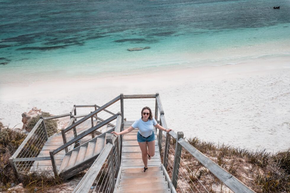 Rottnest Island stairs White sand beach blue water girl walking