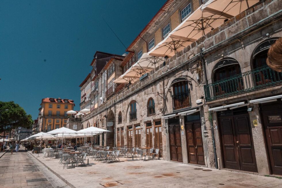 portugal street with litte cafes and blue sky