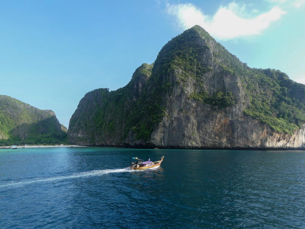 thai islands with rocks and boat on the ocean on a 2-week island hopping itinerary through thailand beaches