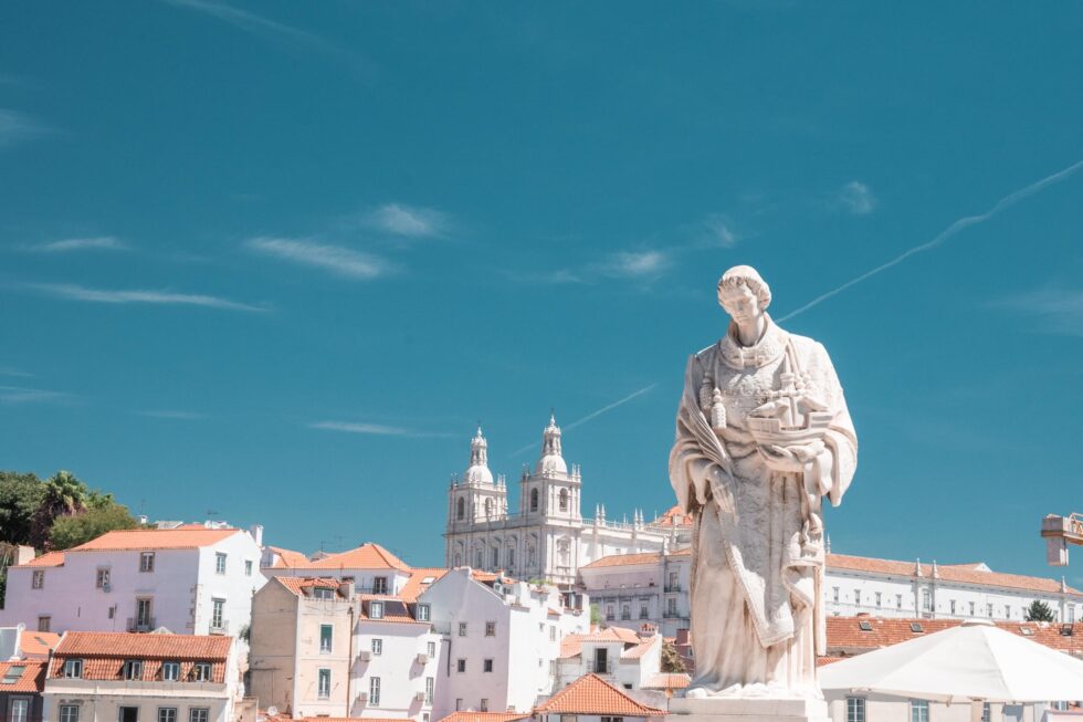 lisbon blue sky white statues white houses alfama