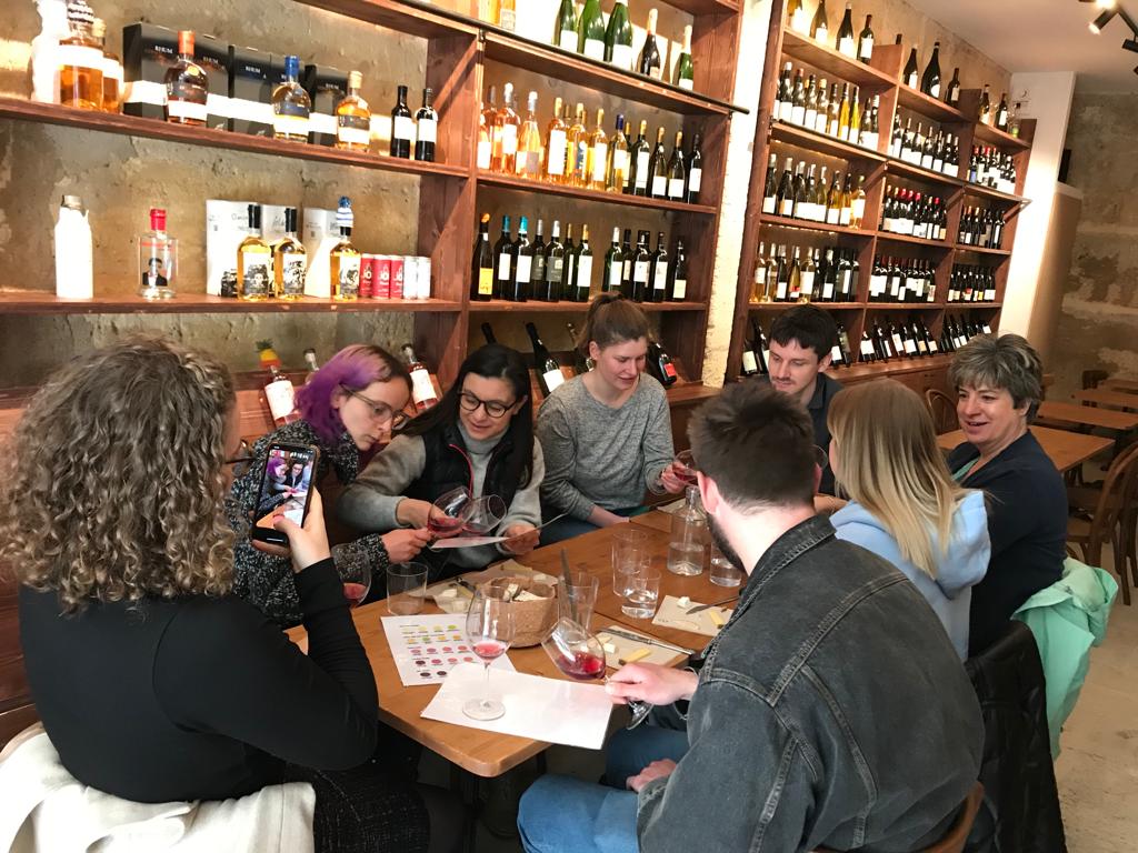 group of people at a wine tasting in bordeaux