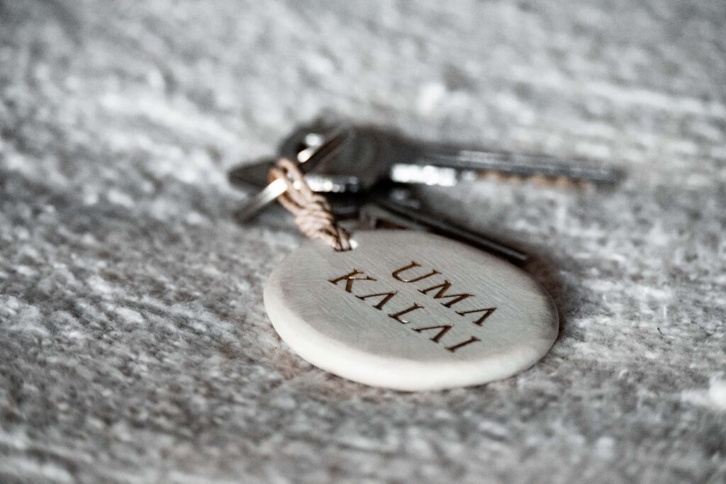 Uma Kalai key on bed with white key chain