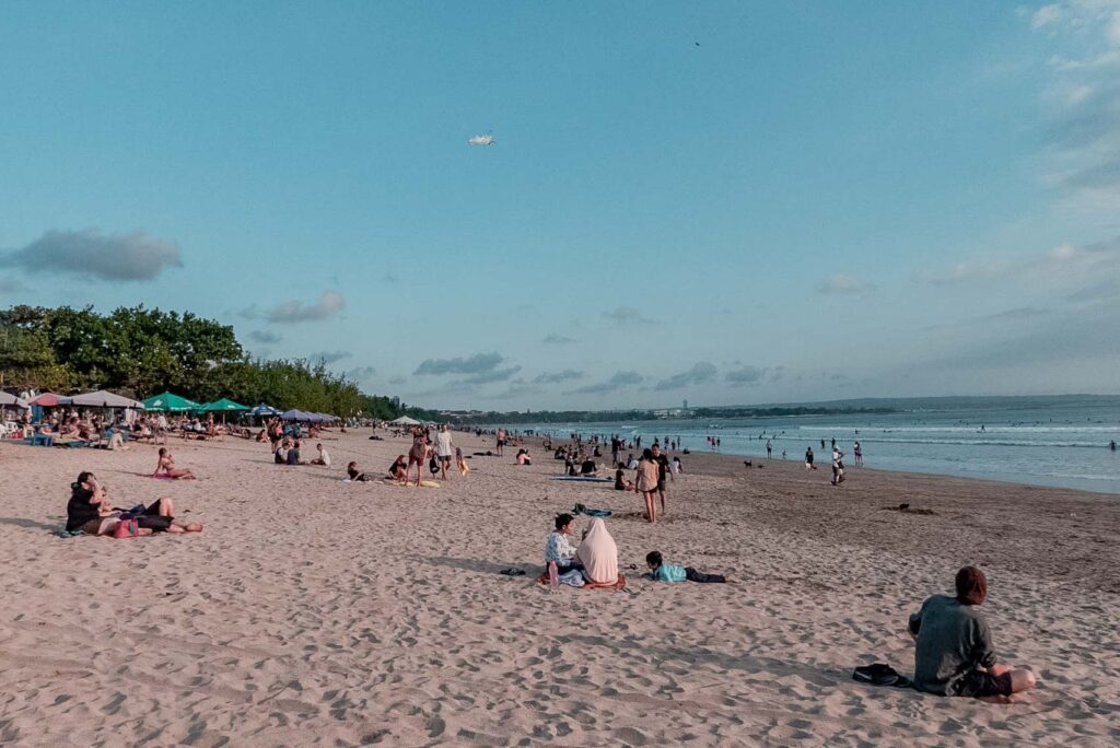 Seminyak Beach blue sky people sitting