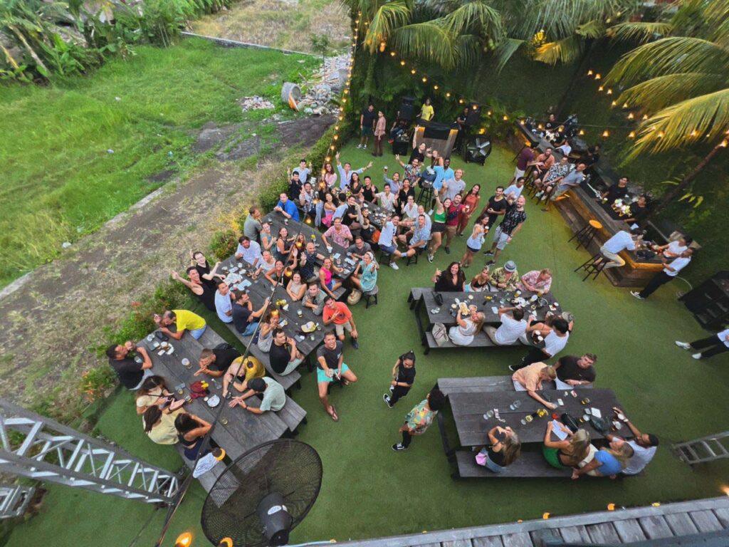 black sand beer garden birthday party bali canggu green lawn picnic tables group of people