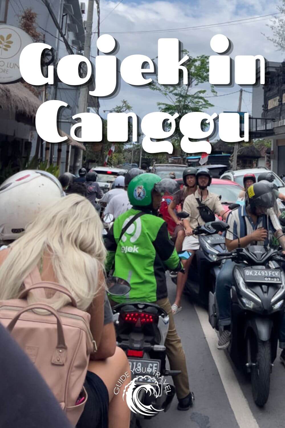 grab driver in Bali in traffic gojek green jacket Canggu