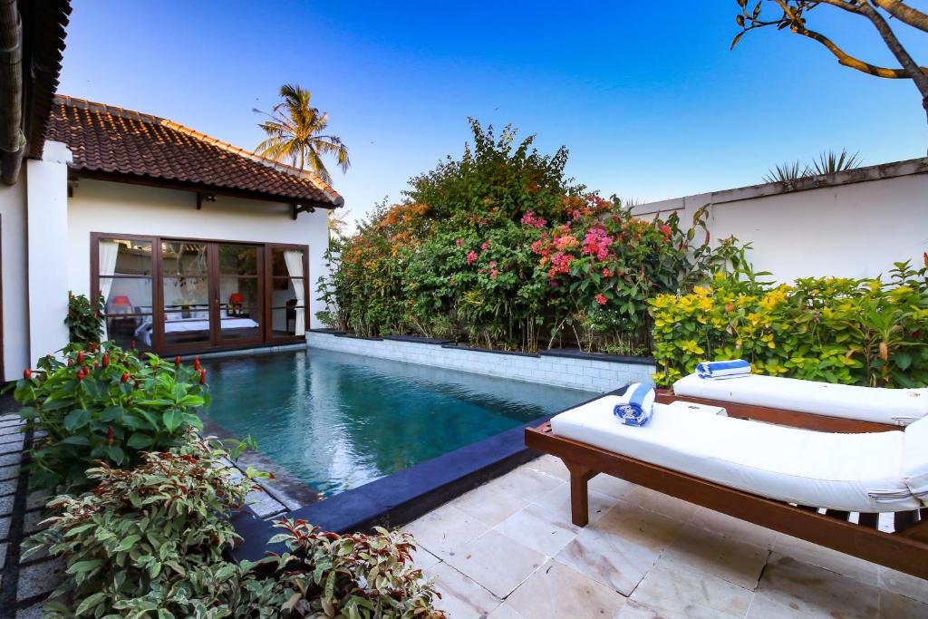 bedroom villa overlooking private pool, sunloungers and flowers