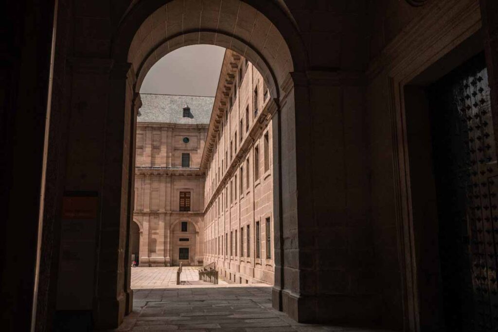 Dark halway with brightly lit courtyard of histroic building and architecture