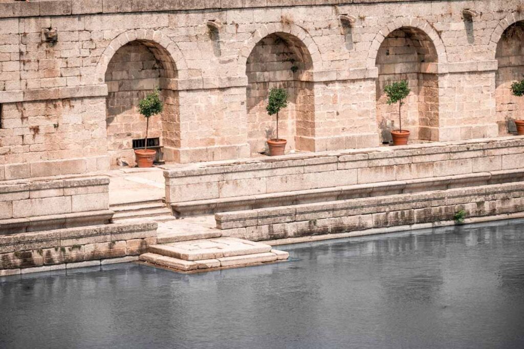 pond with blue water and marble steps down to the water