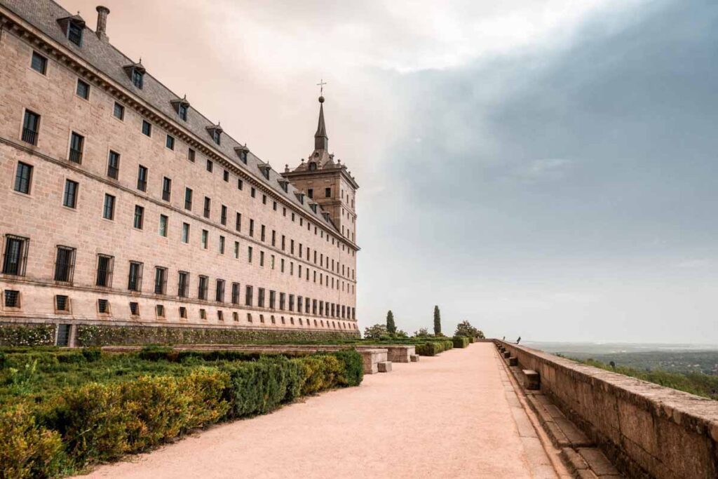 El Escorial monastery with blue skies and clouds after forest fire gardens