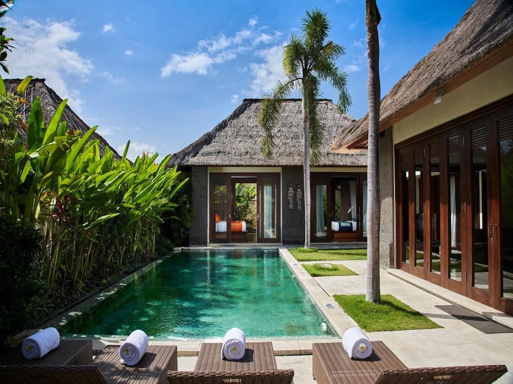 Villa with private pool banana palm sunloungers in Sanur hotel