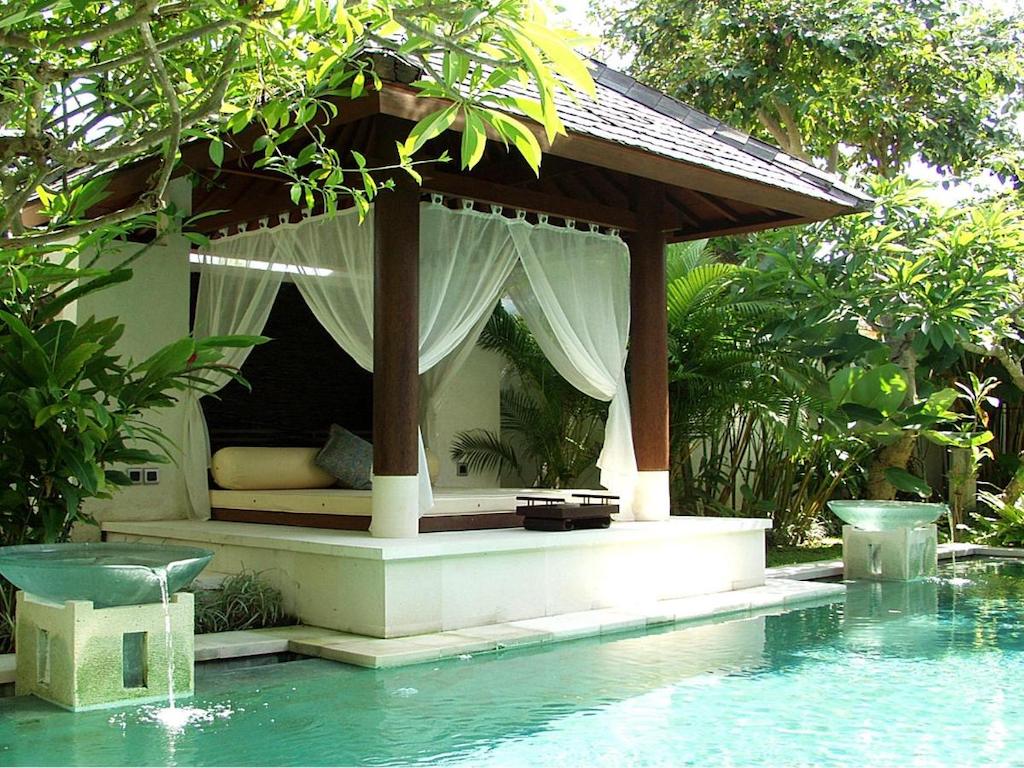  pool and pavilion surrounded by green garden and small fountain