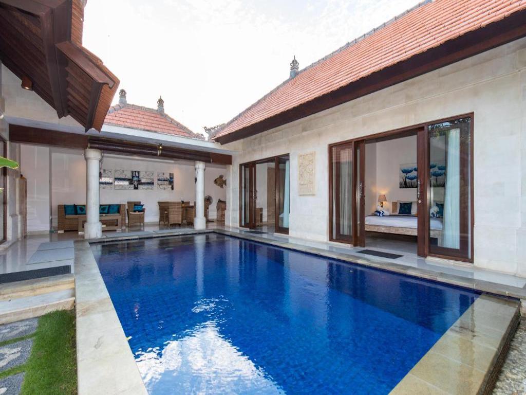 room overlooking the pool with a lounge and outside dining area 