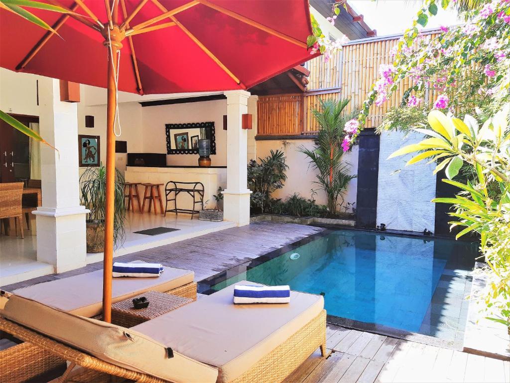 kitchen and living room overlooking private pool with sunbeds and parasol