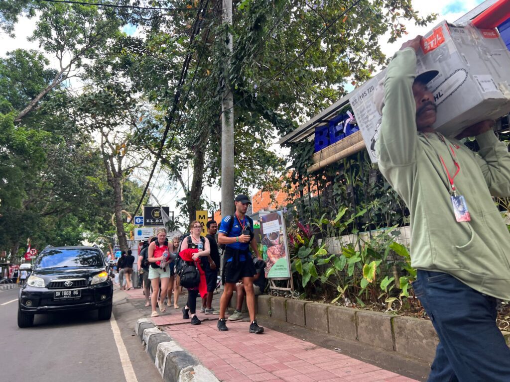 People walking on the sidewalk in Sanur