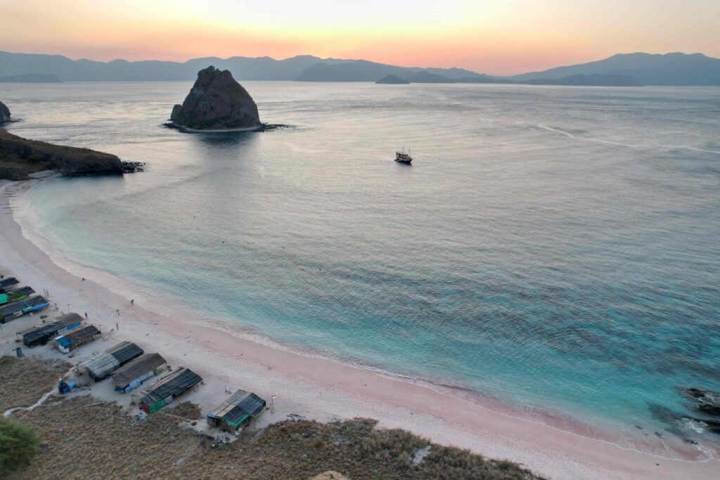 pink beach komodo sunset blue water warungs