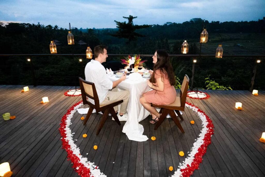 couple at romantic dinner at uma kalai boutique resort heart shaped petals