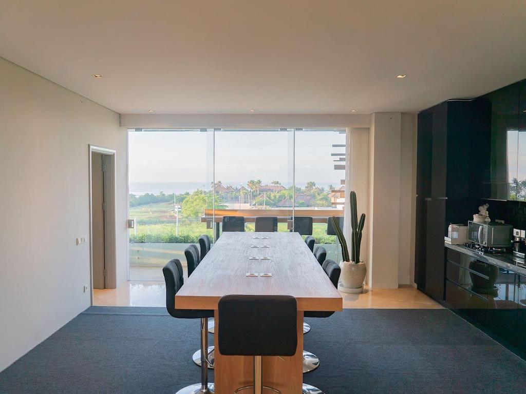 table in a coworking space with a view of the rice paddies and the sea