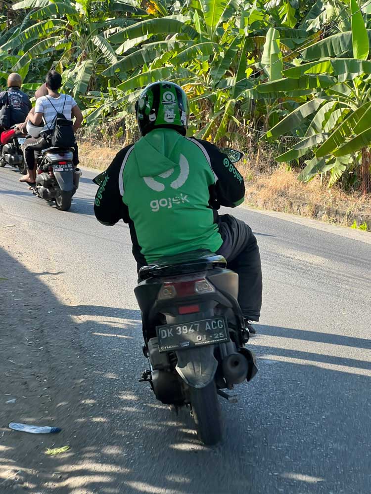 gojek grab motorbike driver on a bike leaning in a sharp turn