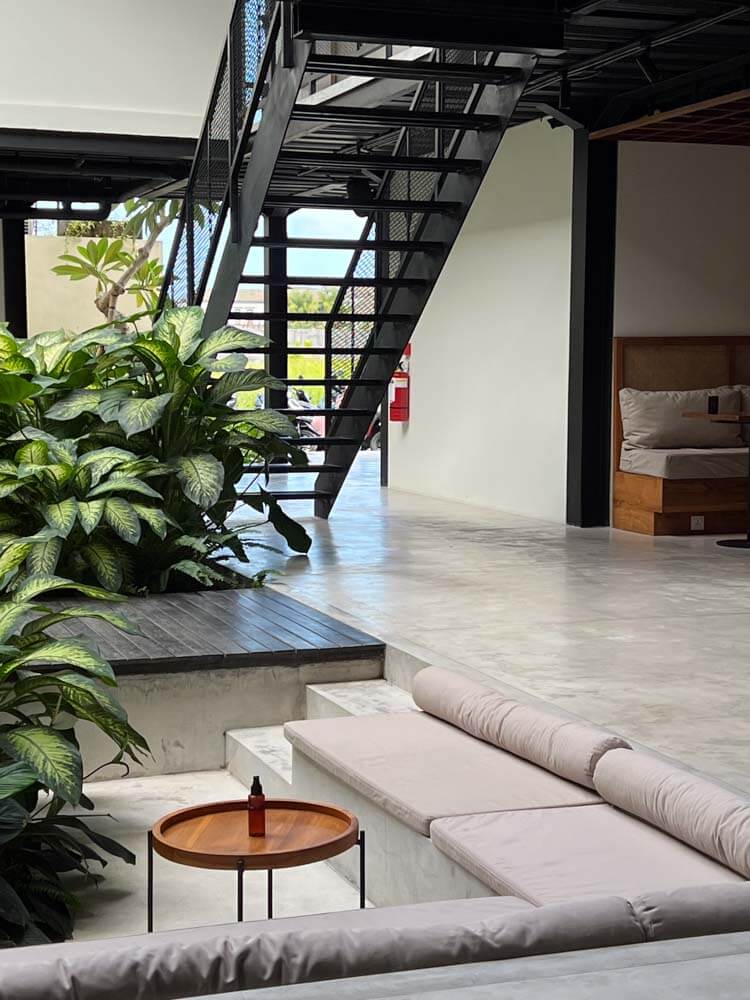 tribal coworking space in Canggu with metal stairs, couches and plants