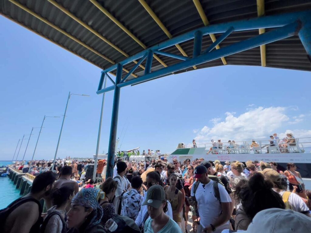 crowded pier in gili trawangan with people waiting for boats which commonly make tourists seasick