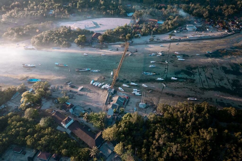 drone shot of yellow bridge in nusa lembongan at dawn