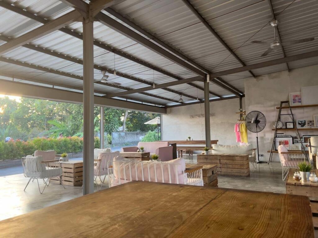 crate cage in canggu with metal roof, tables and couches