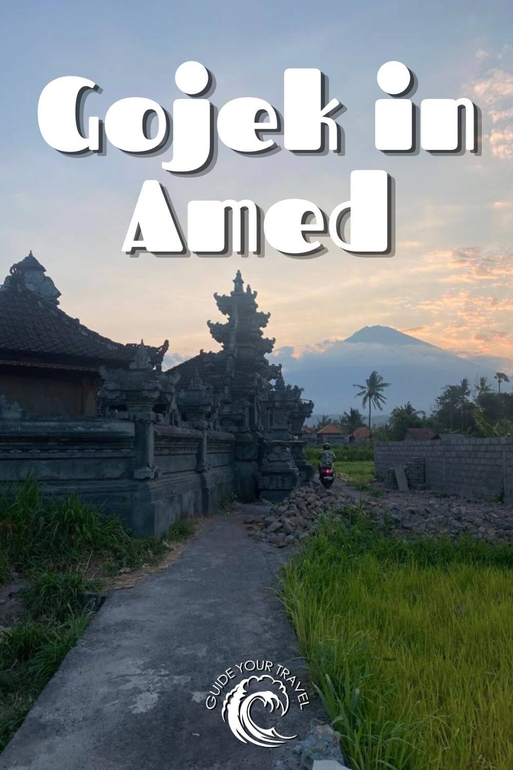 gojek and grab in Amed during sunset volcano view and road next to temple