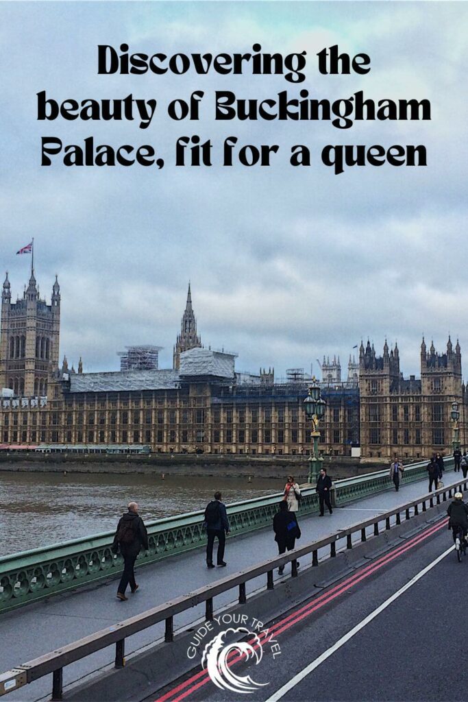 view of Buckingham Palace from a bridge with people walking 