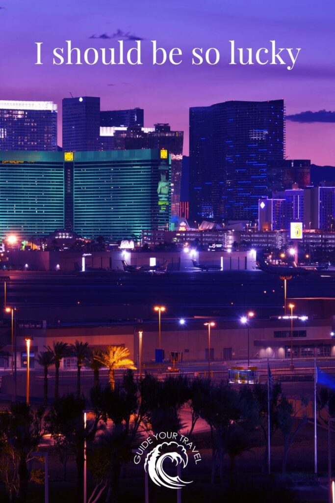 view of Las Vegas airport at sunset with a purple sky and planes on the runway 