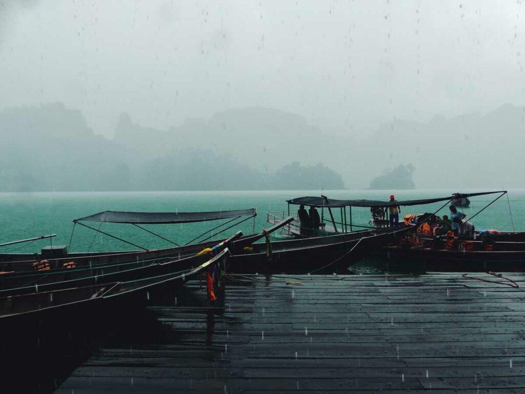 rain in khao sok national park hazy foggy boats