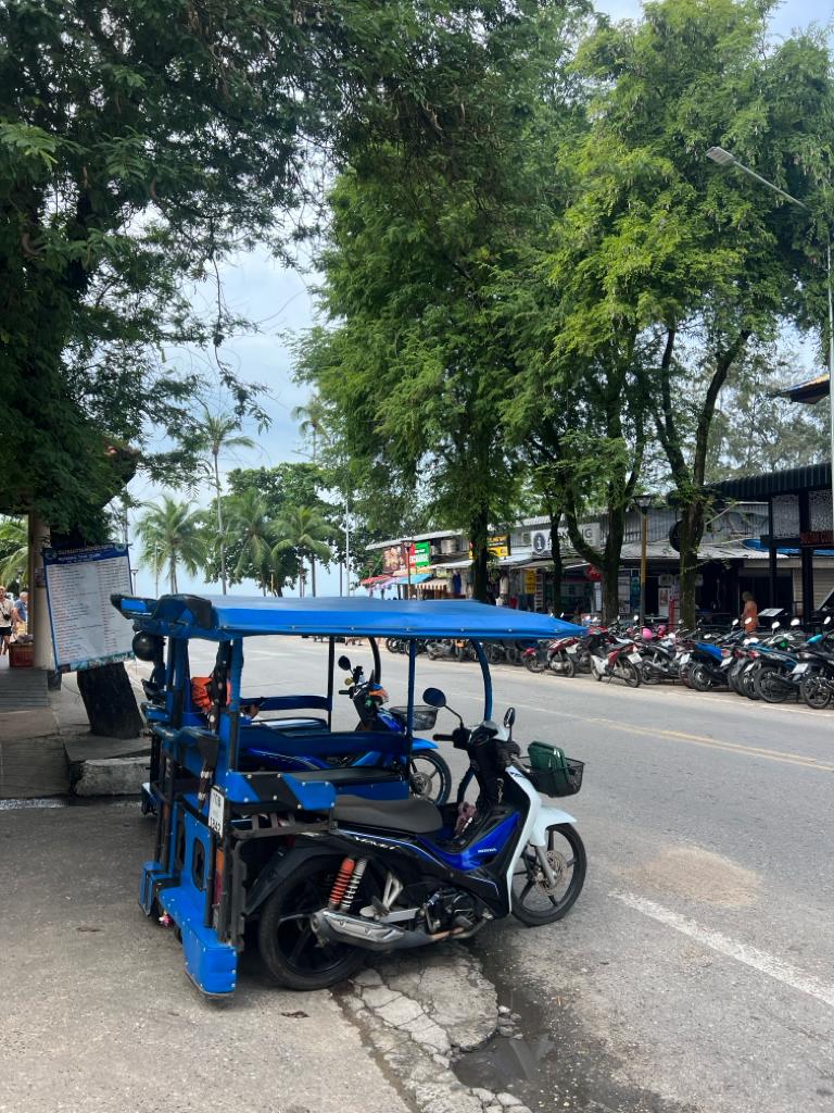 street with blue tuk tuks in ao nang