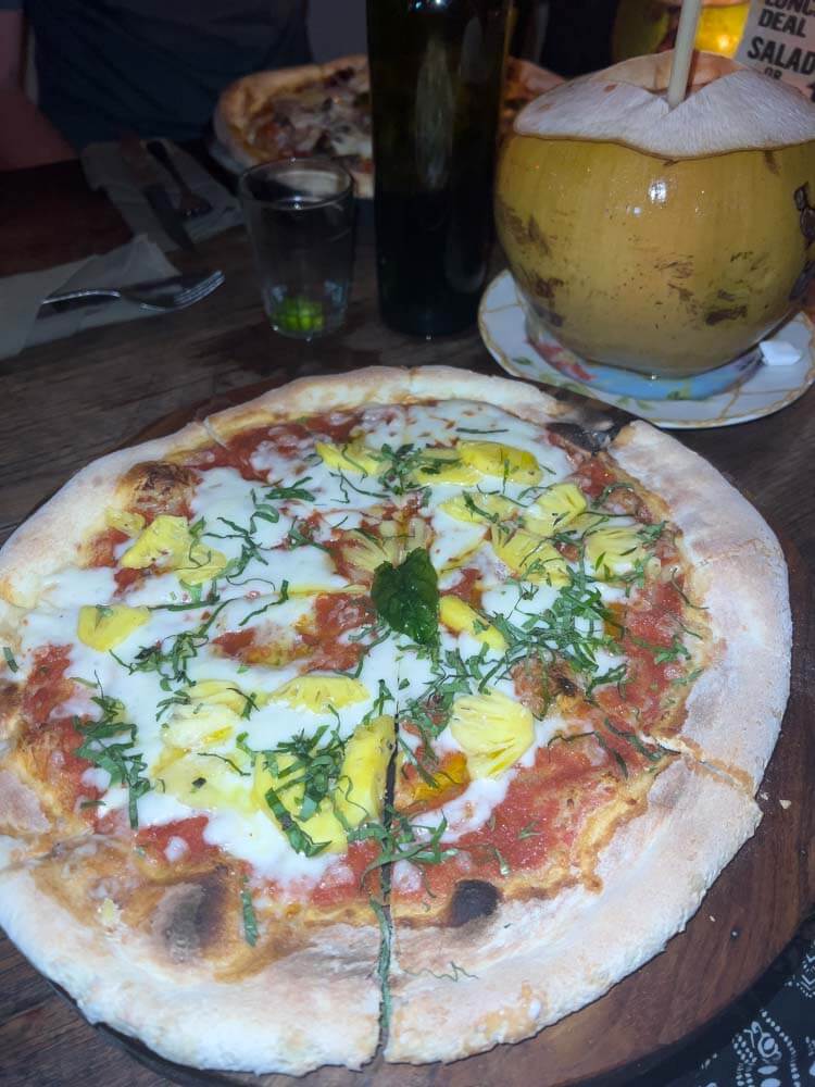 pizza with pineapple at la baraccca in canggu for a romantic date night at one of the best restaurants