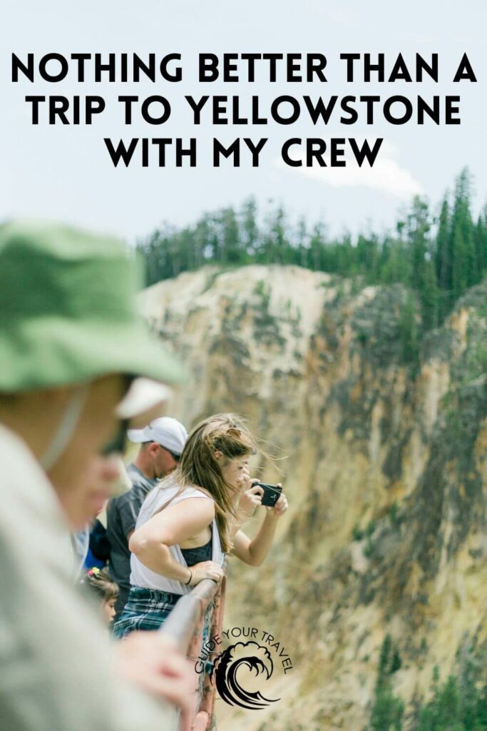 People taking photos at a scenic overlook in Yellowstone perfect for instagram captions and quotes