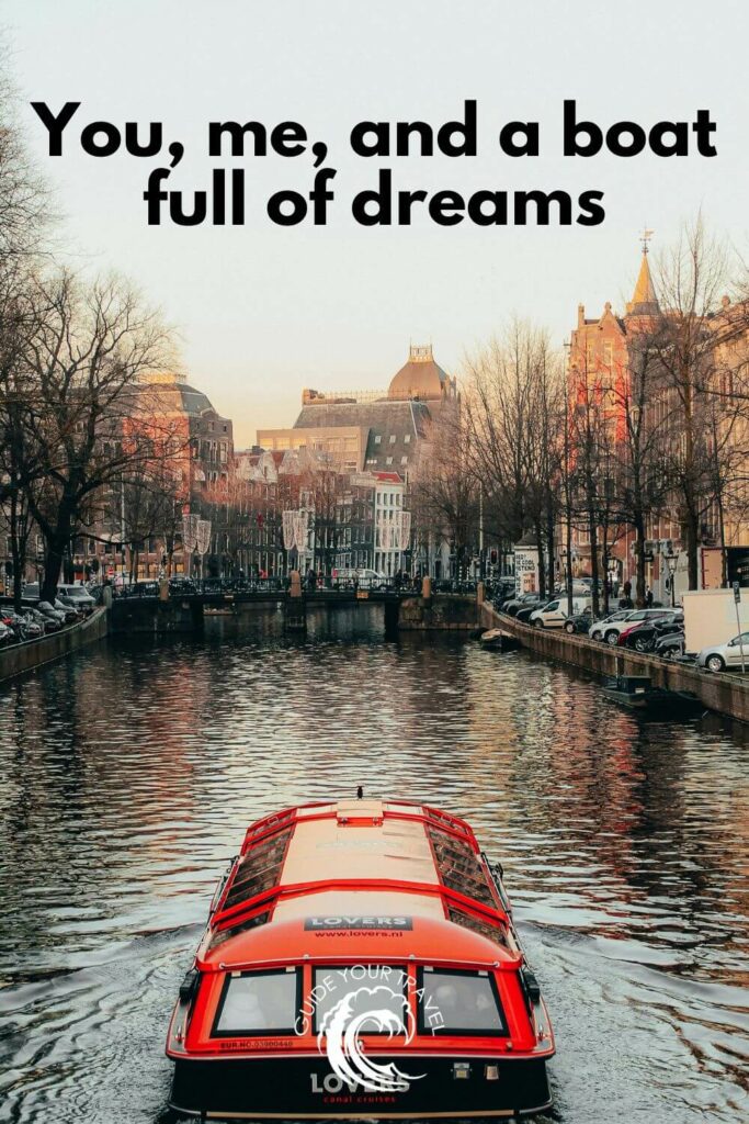 A red boat cruises through a canal Amsterdam Instagram captions and quotes.