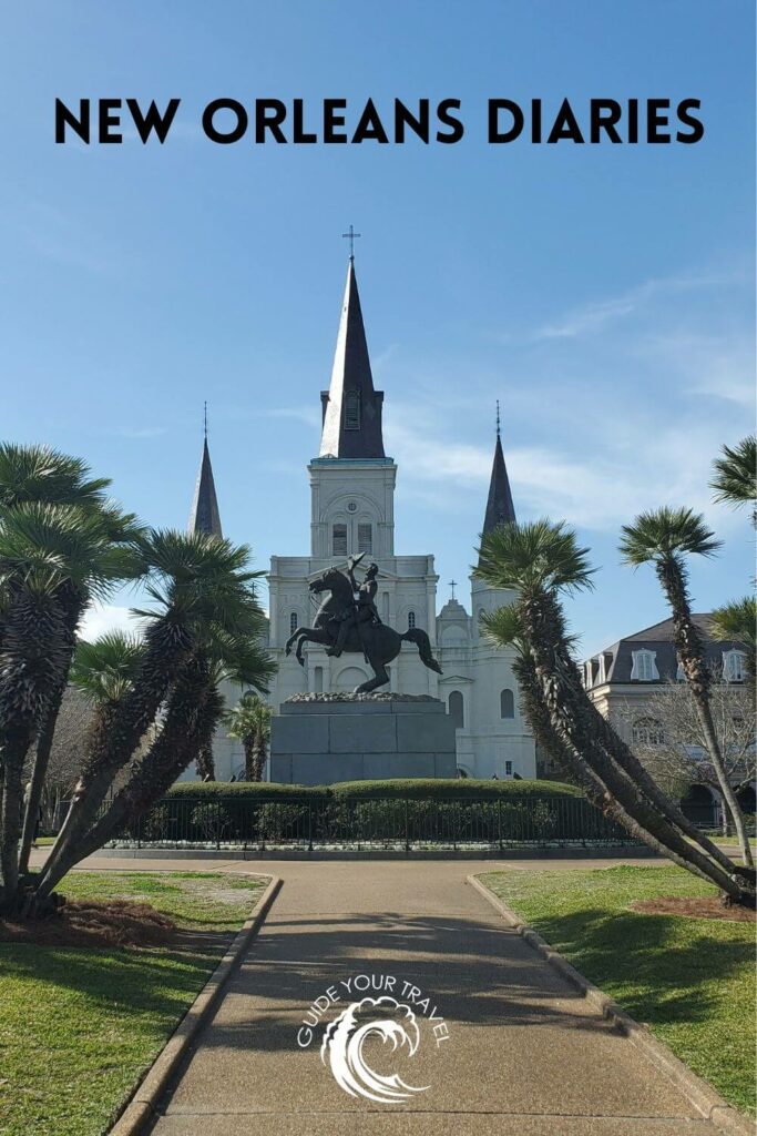 A statue in front of a cathedral with palm trees  perfect for New Orleans Instagram captions and quotes