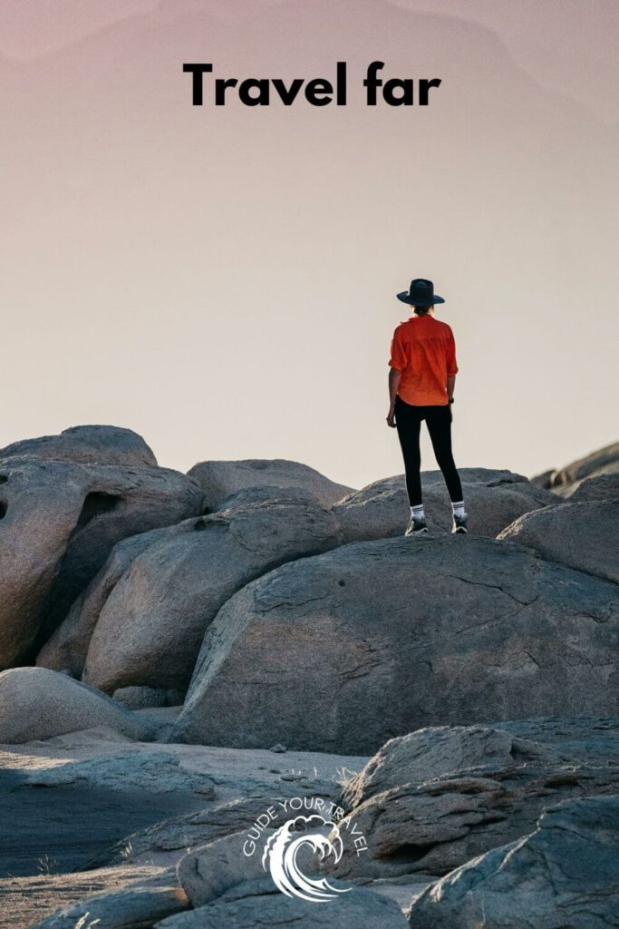 A person standing on large rocks with the best two-word instagram captions