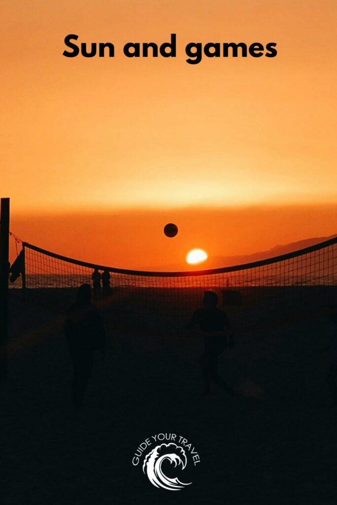 People playing volleyball on the beach at sunset perfect for sun Instagram captions and quotes