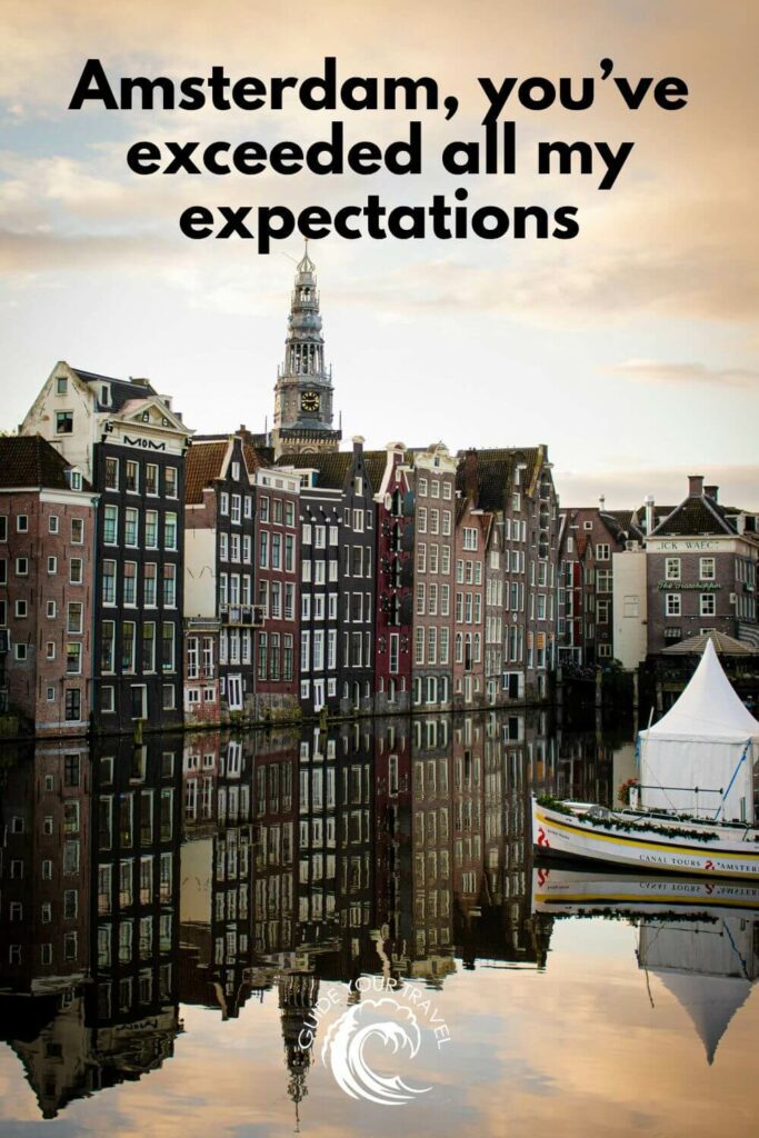 Buildings and a church tower reflected perfectly in a still canal Amsterdam Instagram captions and quotes.