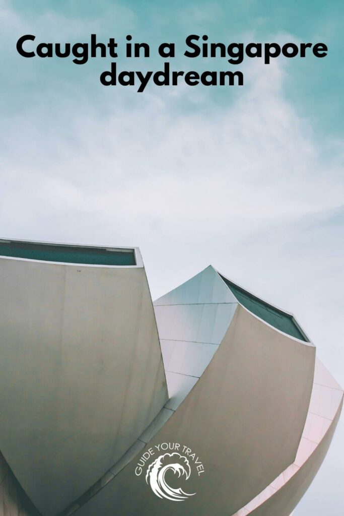 A modern building against a blue sky perfect for Singapore instagram captions and quotes.