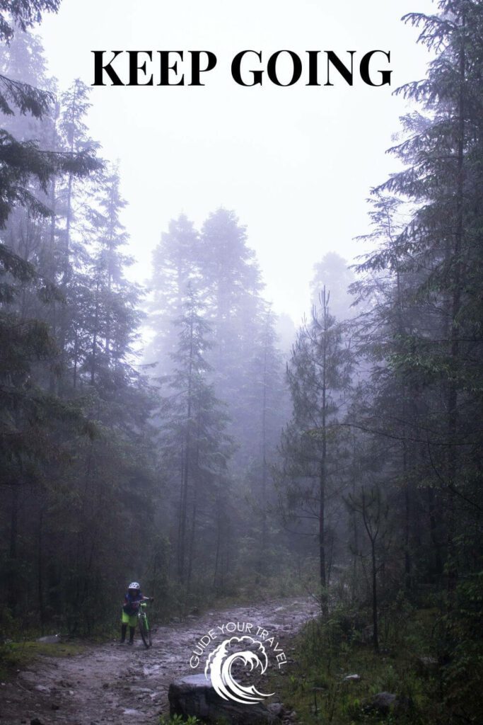 A child pushing a bicycle on a forest with the best two-word instagram captions