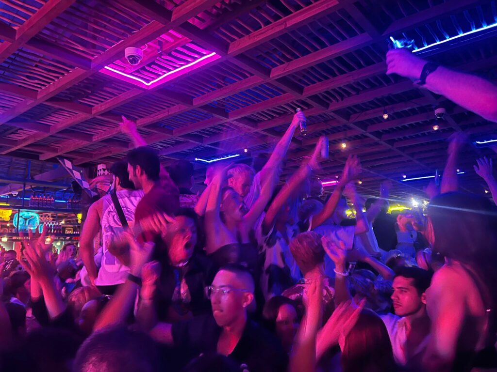 mexicola canggu purple light and people dancing in a night club