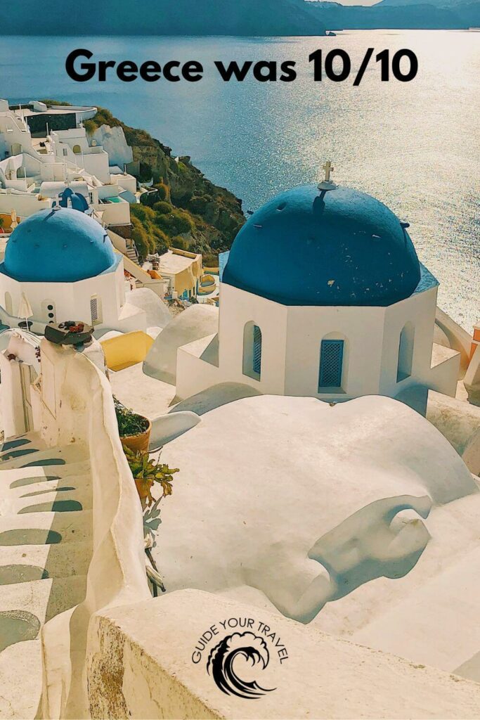 White buildings with blue domes by the sea perfect for Greece Instagram Captions and Quotes