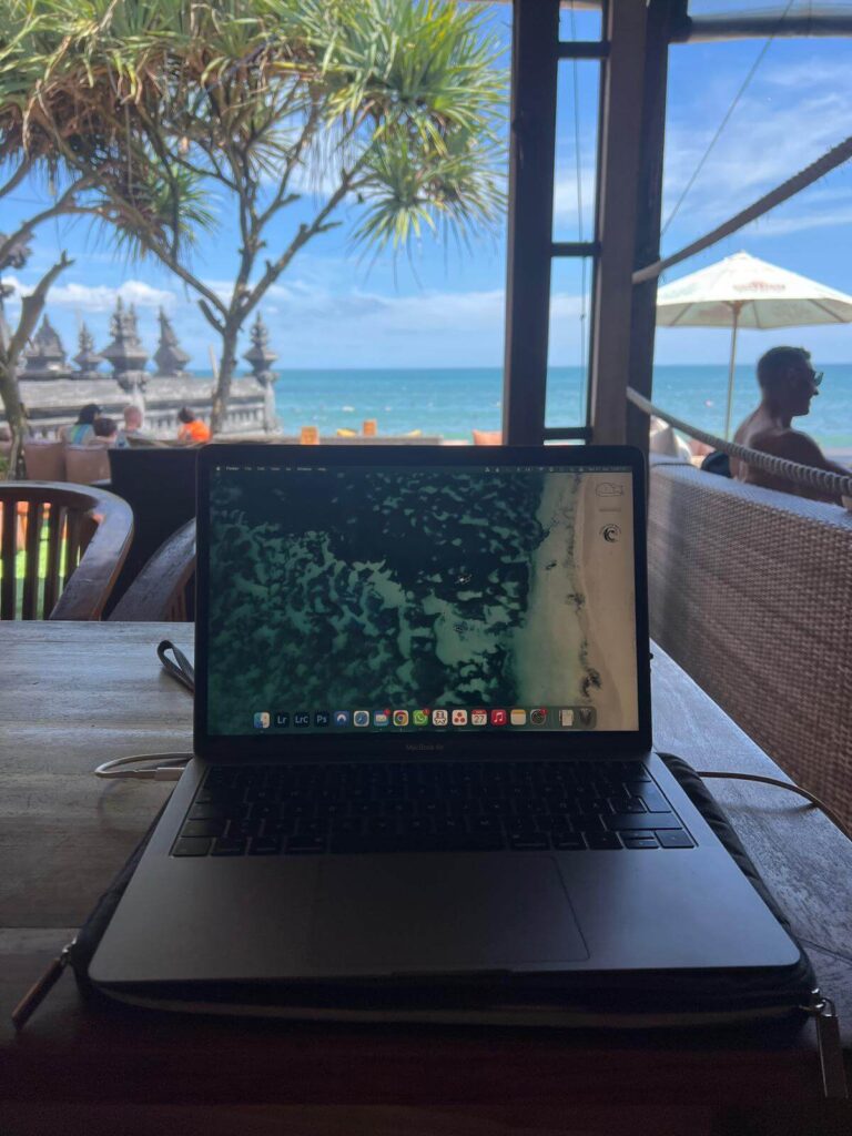 laptop on table overlooking the ocean