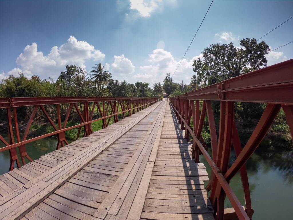 red metal bridge with blue skies